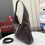 Dark brown leather hobo bag with top handle and attached crossbody strap