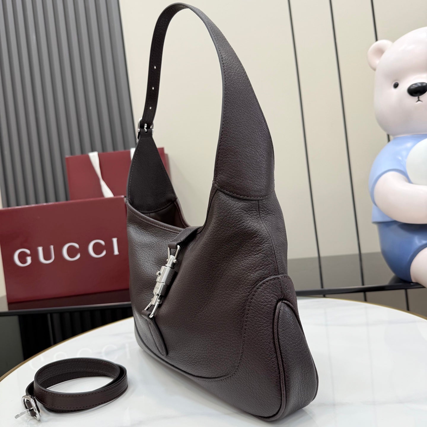 Dark brown leather hobo bag with top handle and attached crossbody strap