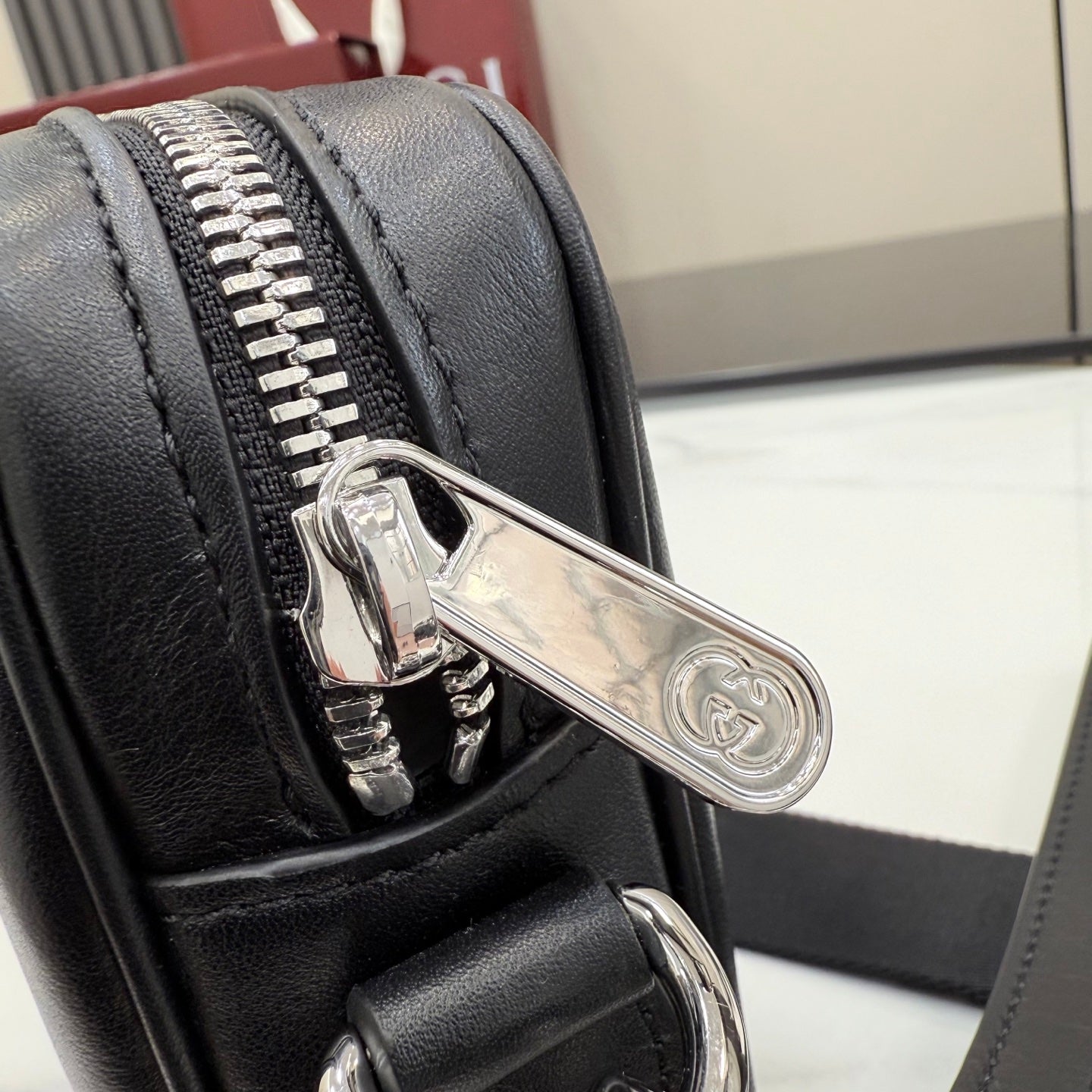 Gucci crossbody bag zipper with silver hardware on black leather