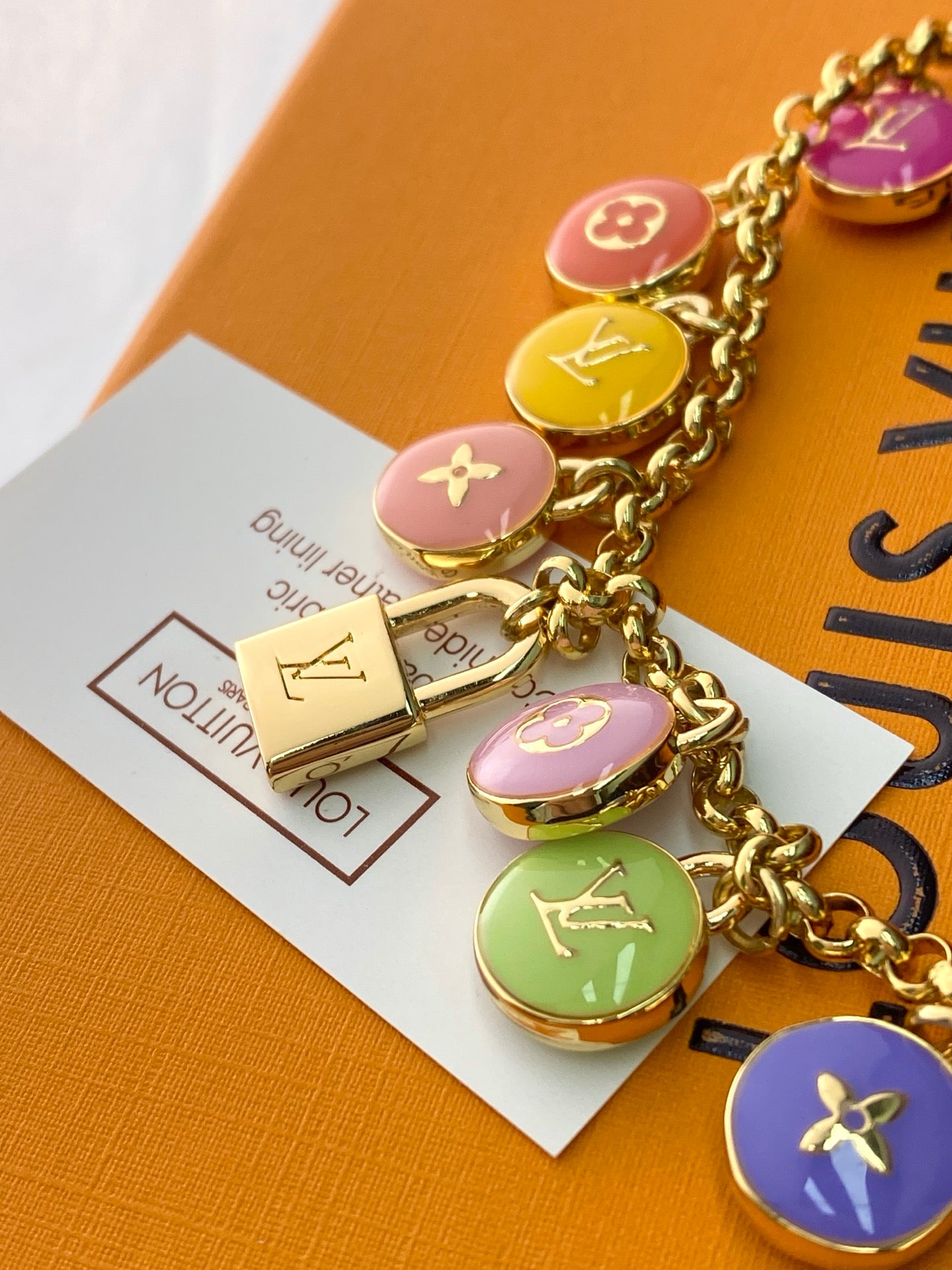Louis Vuitton small bag charm bracelet with gold chain and colorful round charms