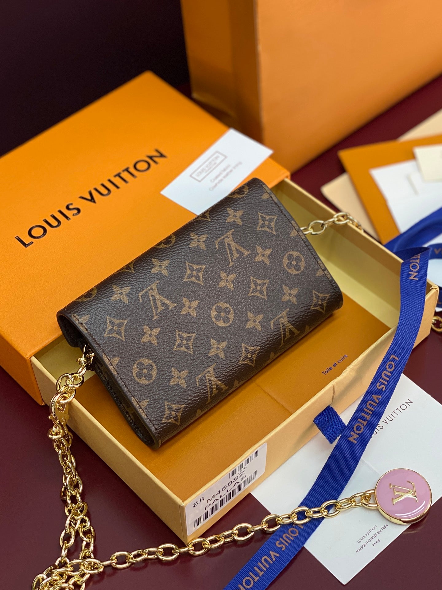 Louis Vuitton small bag in monogram canvas with gold chain strap and flap closure
