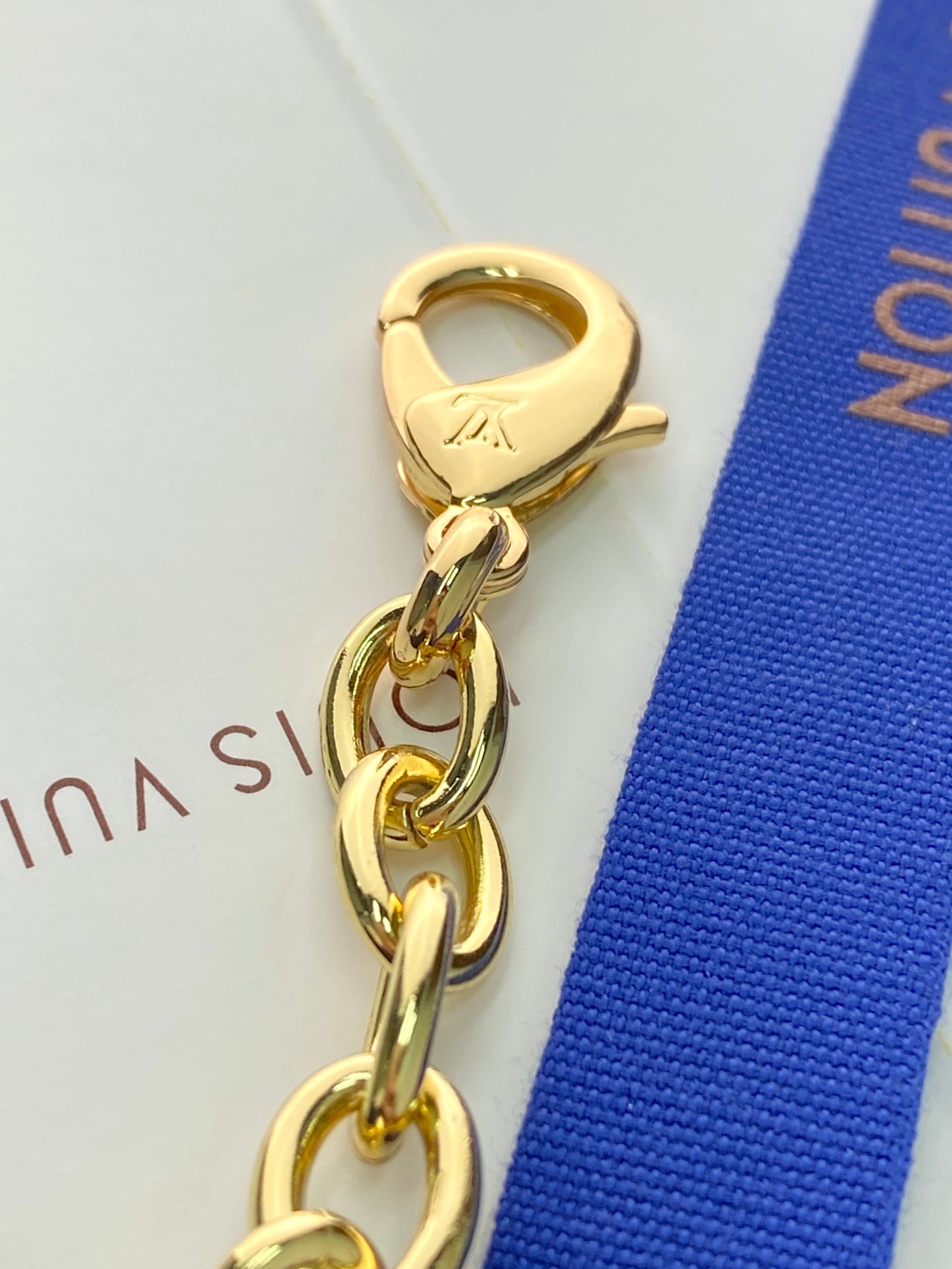 Louis Vuitton small bag gold keyring clasp with chain link and LV stamp