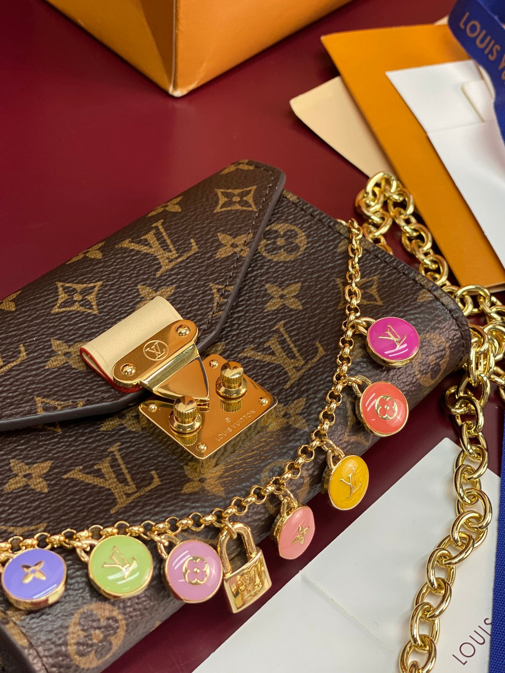 Louis Vuitton monogram flap bag with gold chain and round charm keyring detail