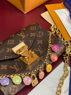 Louis Vuitton monogram flap bag with gold chain and round charm keyring detail