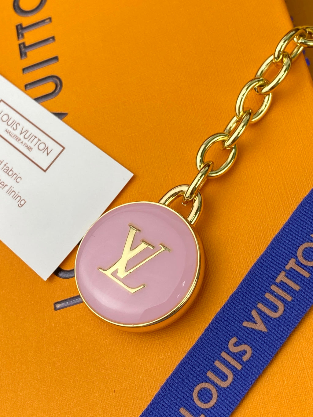 Louis Vuitton small bag round pink charm with gold LV logo and chain
