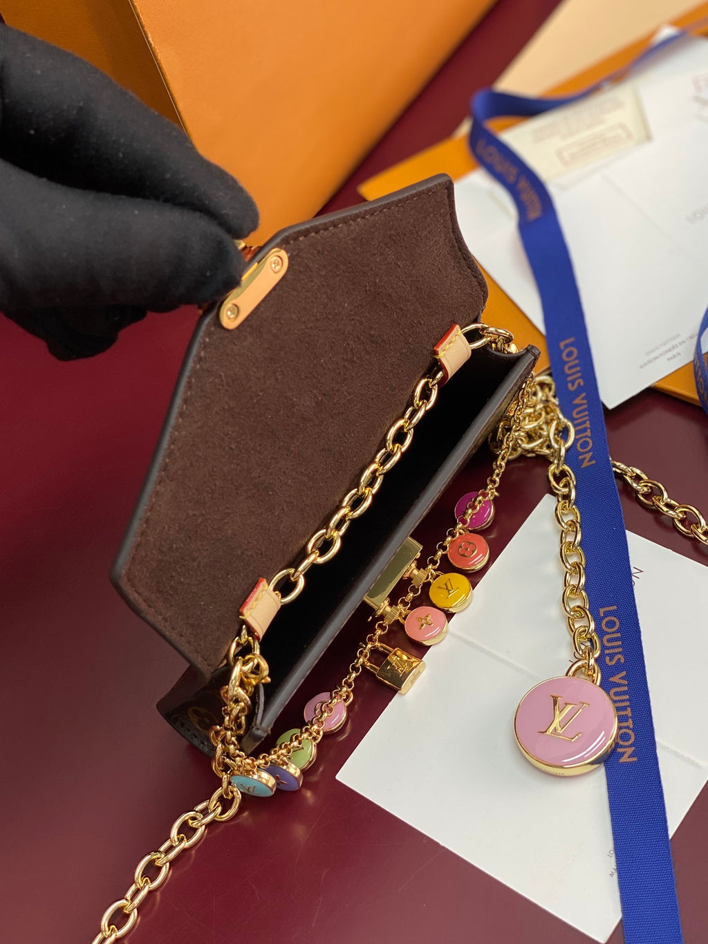 Louis Vuitton small bag with monogram canvas, gold chain strap, charm tag and hardware