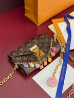 Louis Vuitton small bag with monogram canvas flap, gold chain strap, colorful round charms