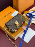 Louis Vuitton monogram flap bag with gold chain and multicolor charm accents