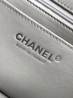 Close-up of Chanel label inside quilted leather bag, gray text "Made in France"