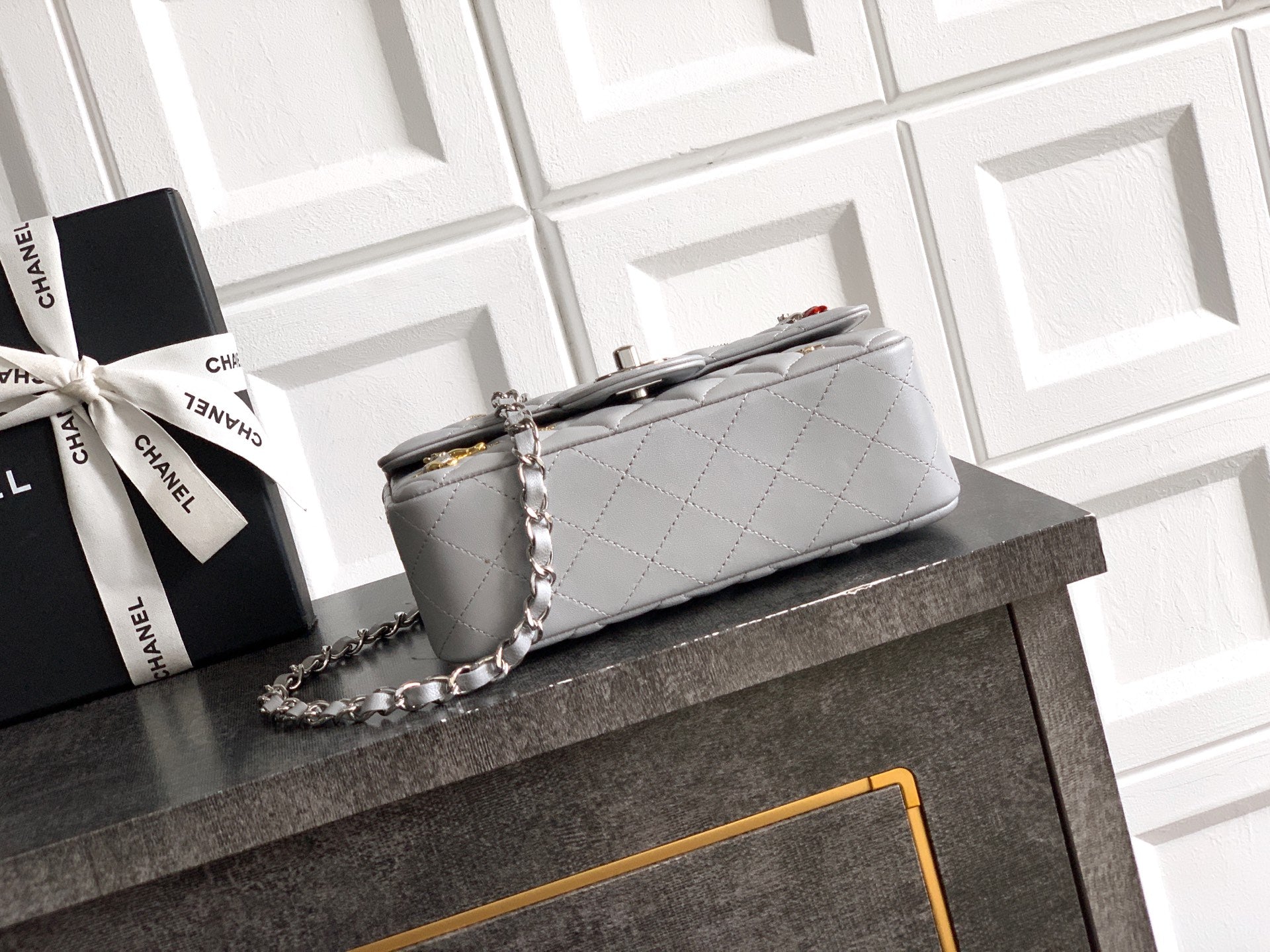 Small quilted leather flap bag with chain strap and top handle, gray