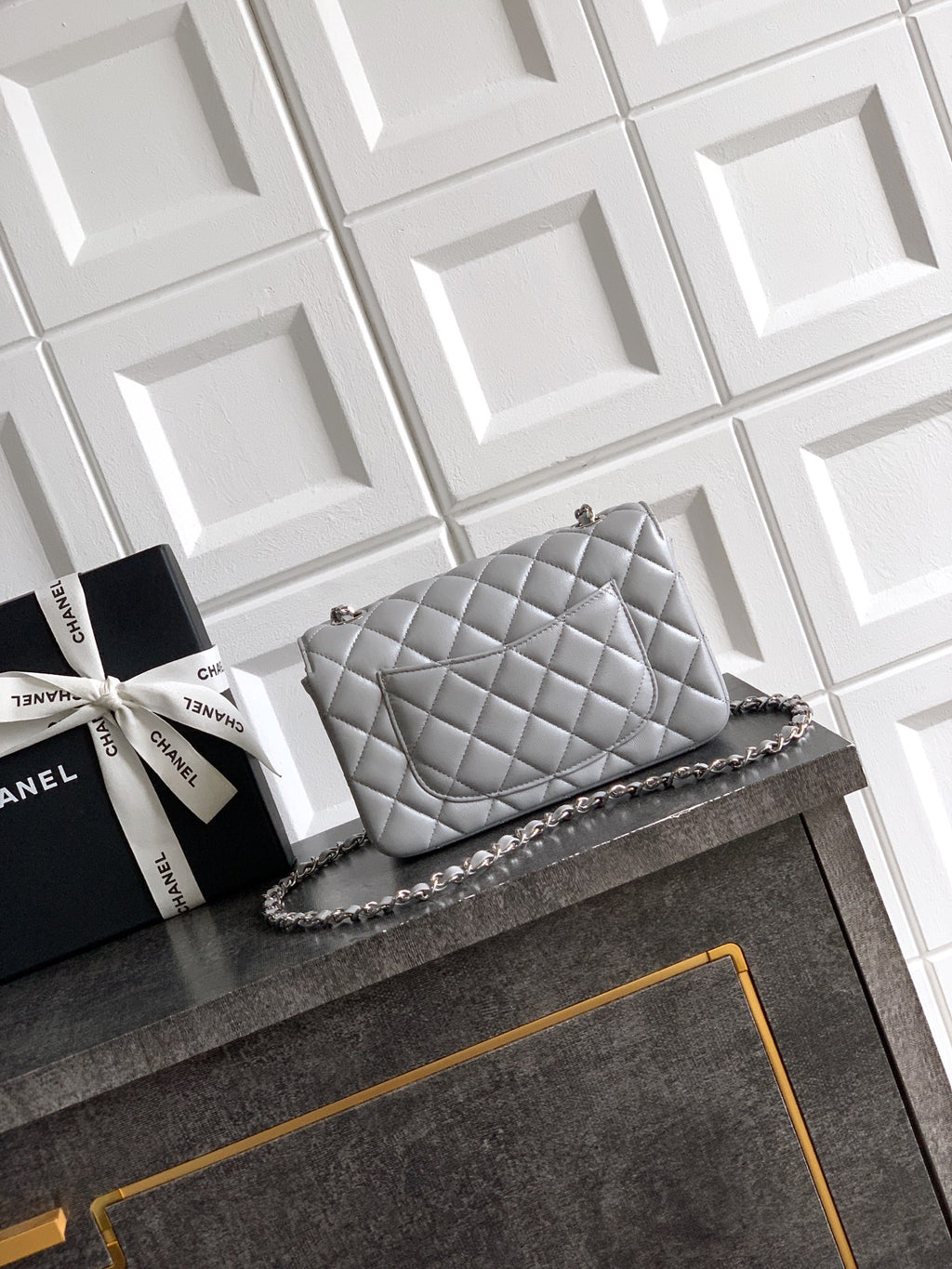 Quilted leather flap shoulder bag with chain strap and gold-tone charms, gray