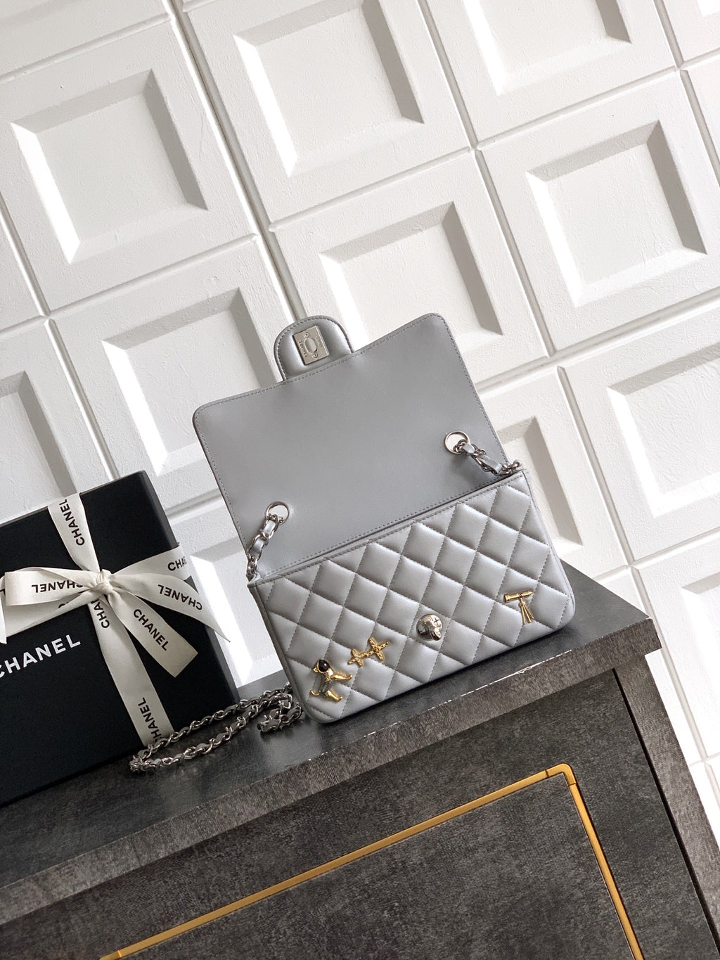 Quilted leather mini flap shoulder bag with chain strap and gold-tone charms, gray
