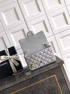 Quilted leather mini flap shoulder bag with chain strap and gold-tone charms, gray