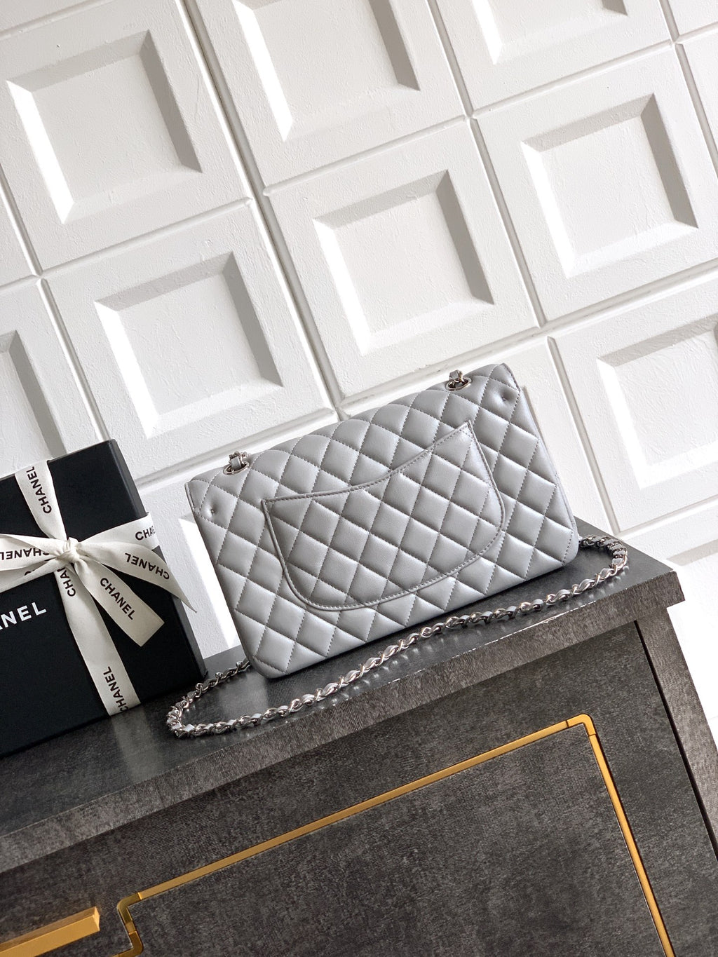 Chanel quilted shoulder bag in light gray with silver-tone chain and turn-lock closure