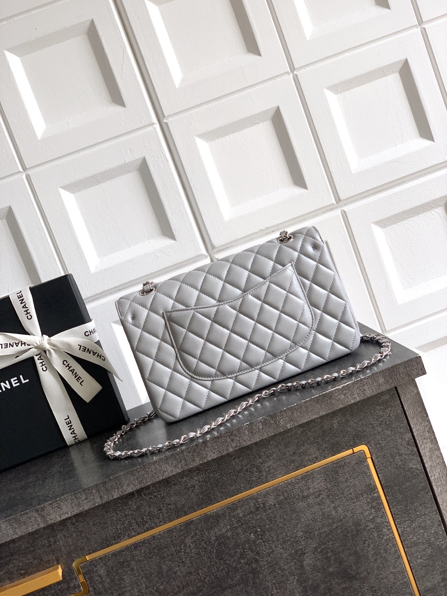 Chanel quilted shoulder bag in light gray with silver-tone chain and turn-lock closure