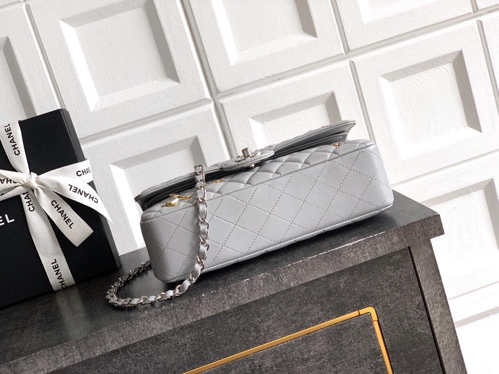 Chanel quilted shoulder bag with long chain strap and top handle, light gray