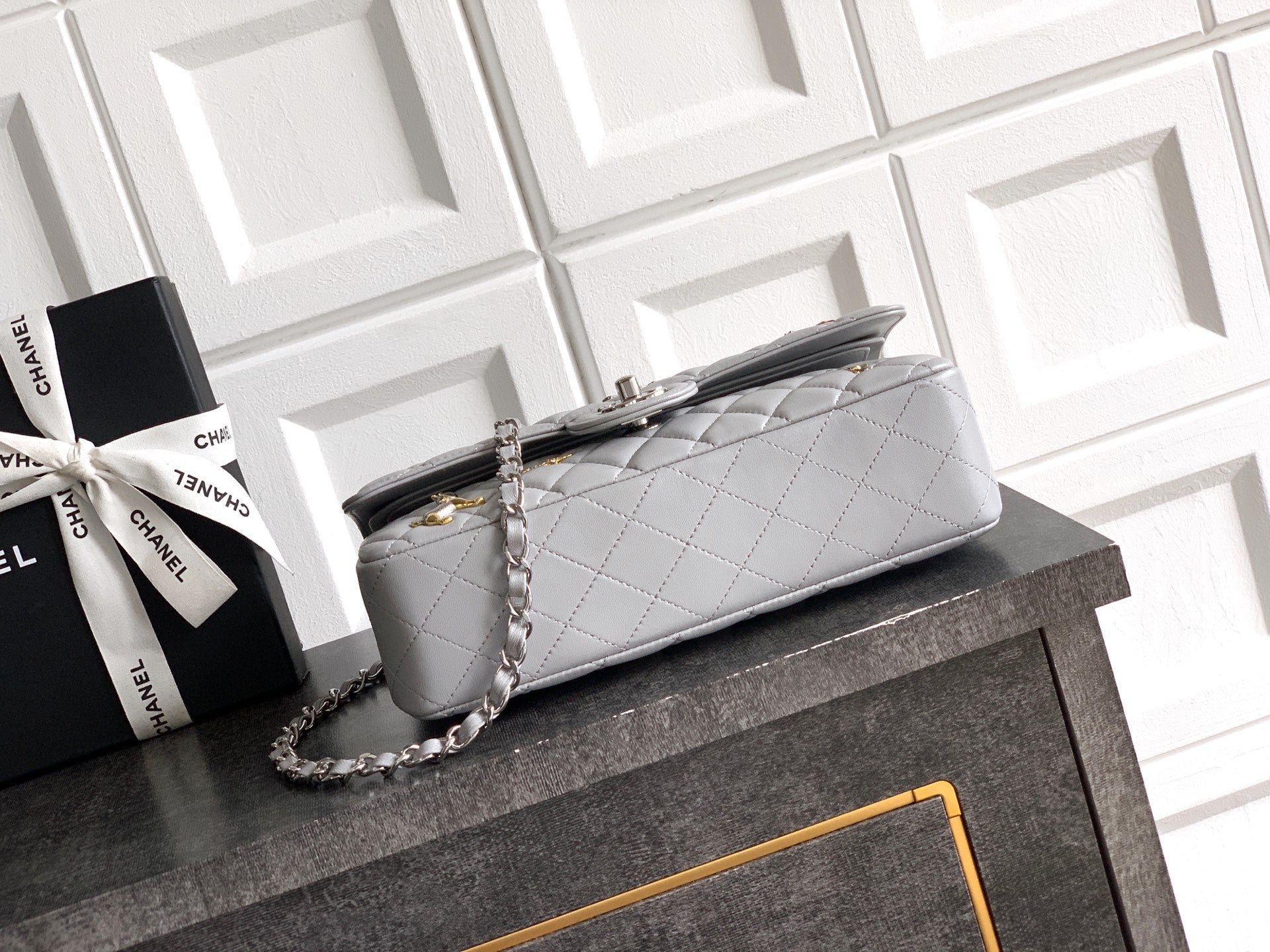 Chanel quilted shoulder bag with long chain strap and top handle, light gray