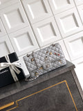 Chanel quilted shoulder bag with silver chain and metal turn-lock clasp, light gray