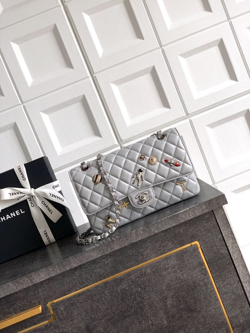 Chanel quilted shoulder bag with silver chain and metal turn-lock clasp, light gray