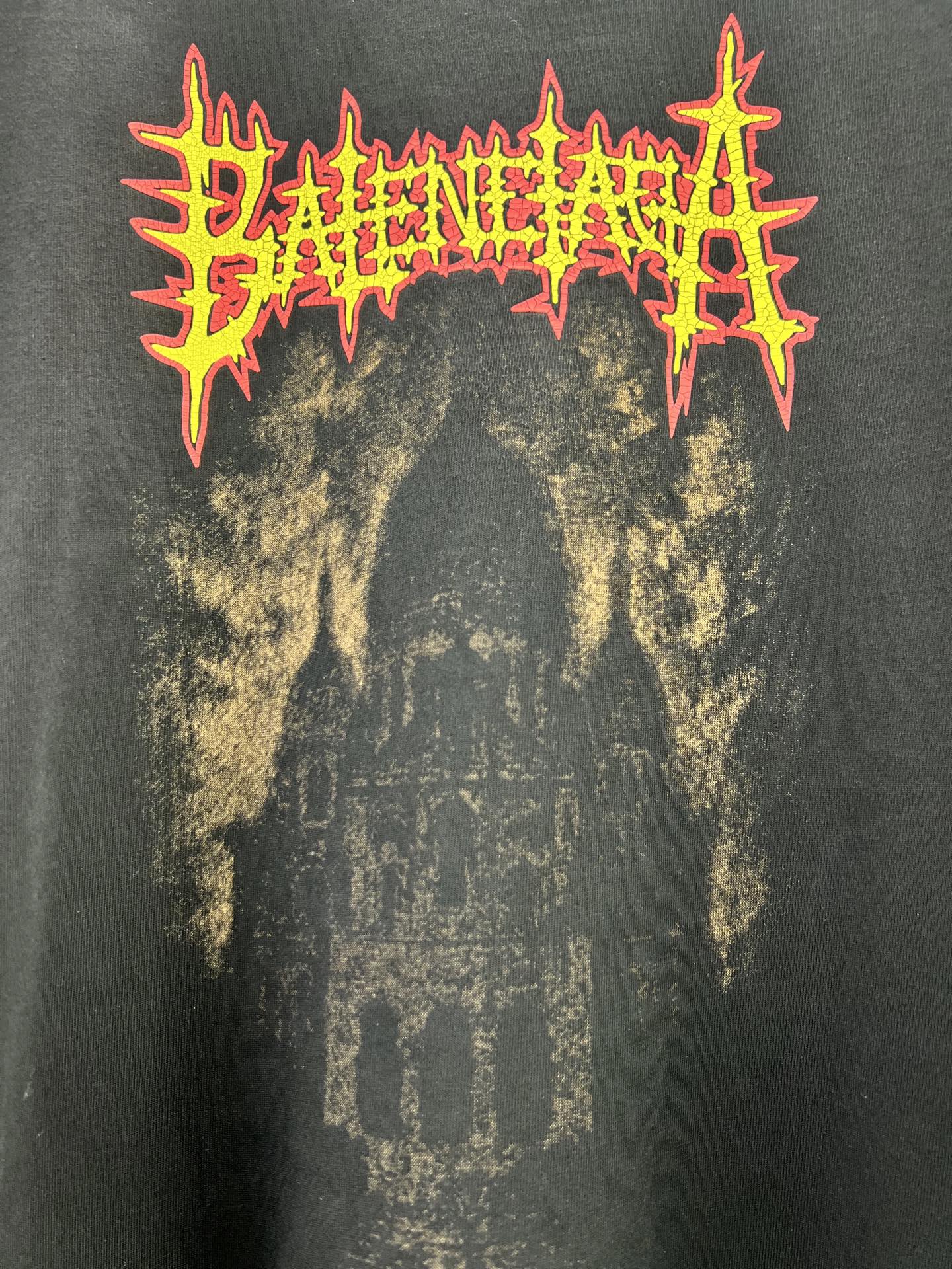 Balenciaga dark T-shirt with large orange and yellow graphic lettering