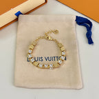 Gold-tone tennis bracelet with clear square stones and small logo charm