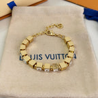 Gold-tone bracelet with square clear stones and hinged chain clasp