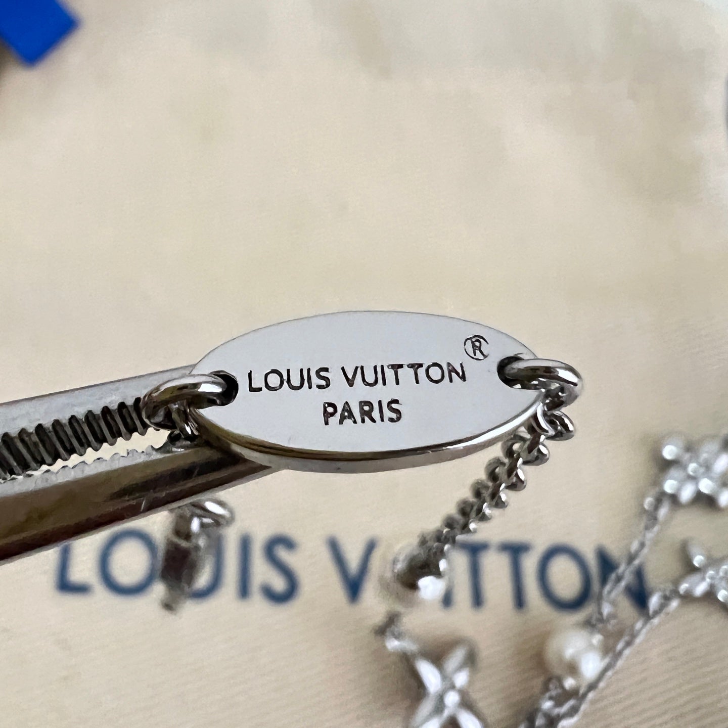 Oval Louis Vuitton Paris medallion on silver-tone charm bracelet with pearl accents
