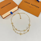 Gold-tone multi-strand charm necklace with pearl beads and star motifs