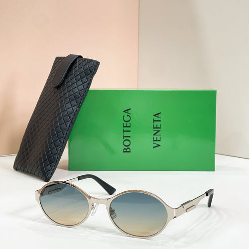 Gold-tone round sunglasses with blue-tinted lenses and black quilted case
