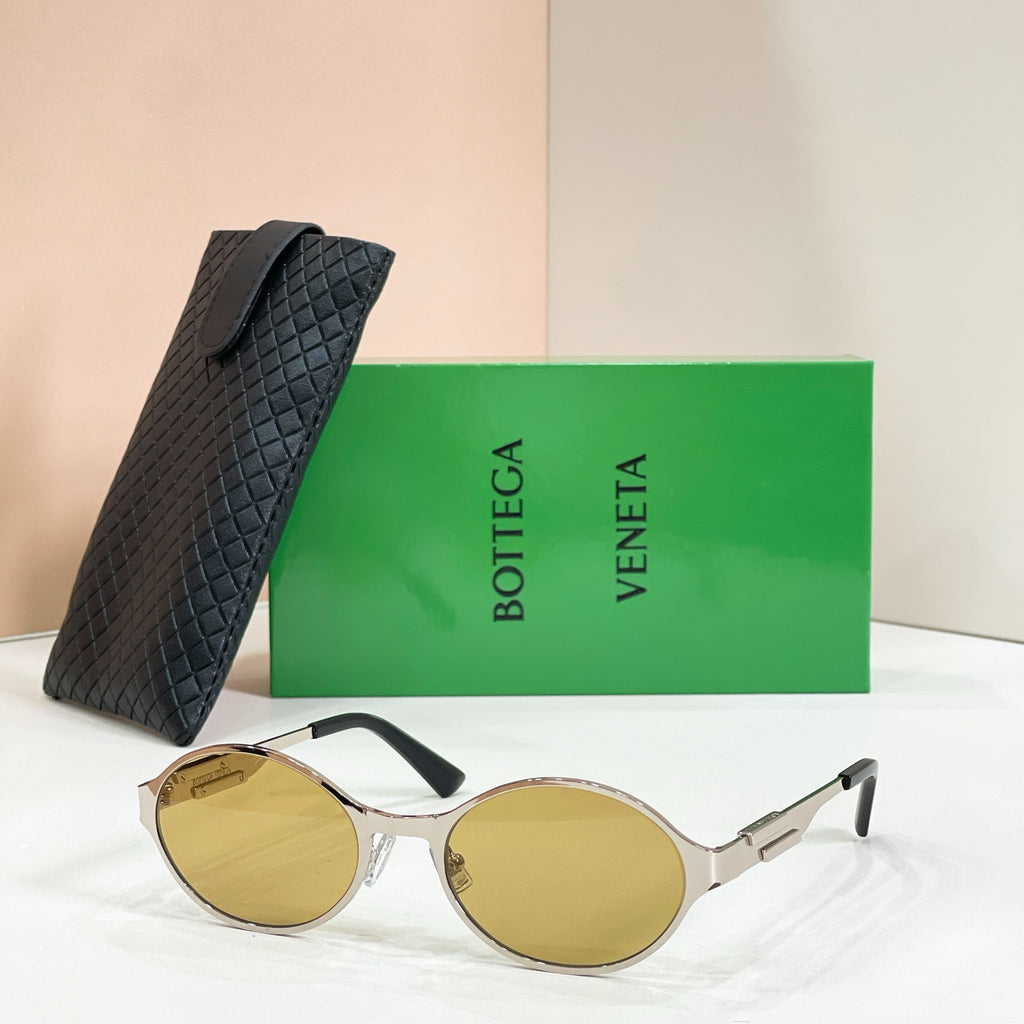 Gold-tone round sunglasses with amber-tinted lenses and black quilted case