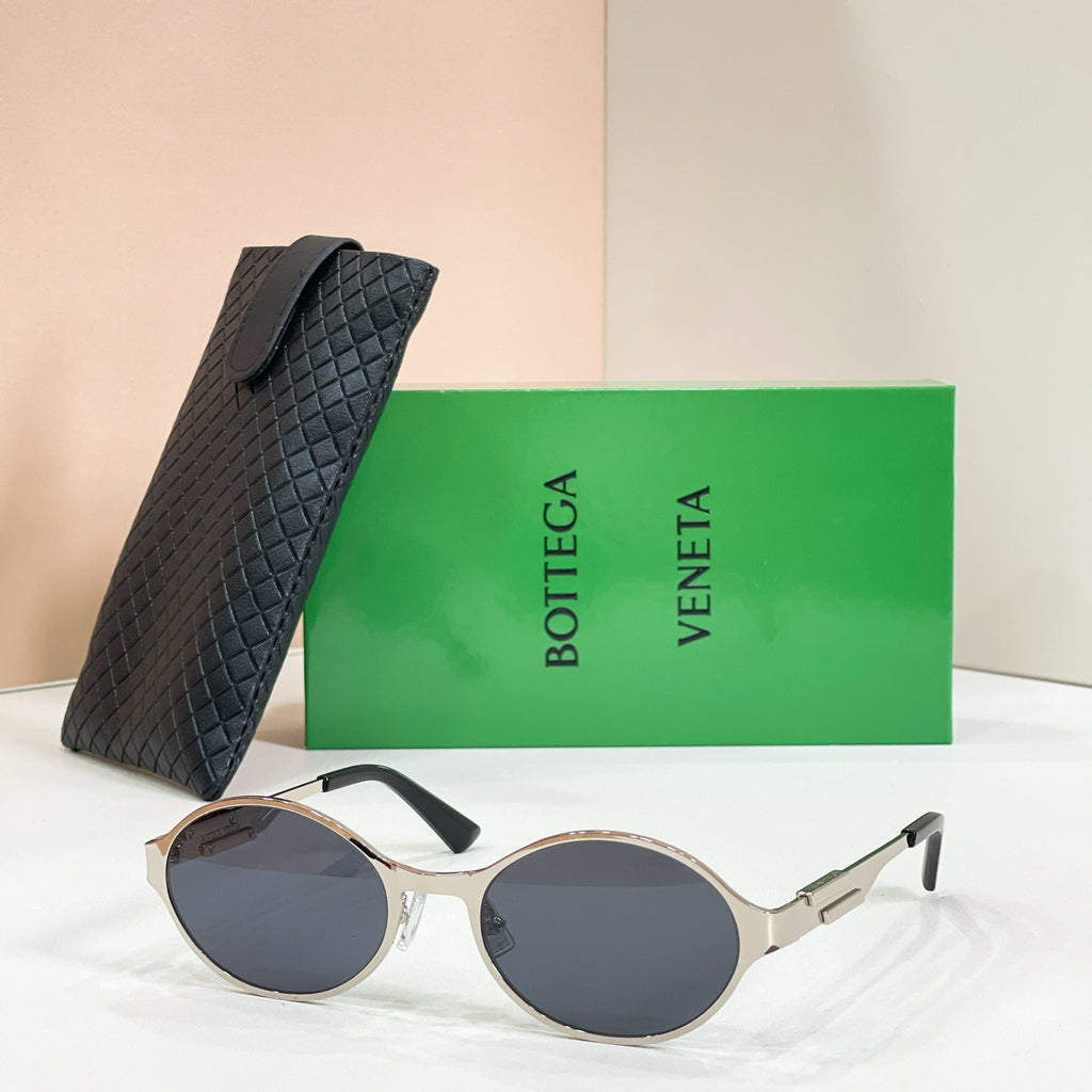 Gold-tone round sunglasses with dark lenses and black quilted case