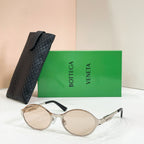 Gold-tone round sunglasses with light-tinted lenses and black quilted case
