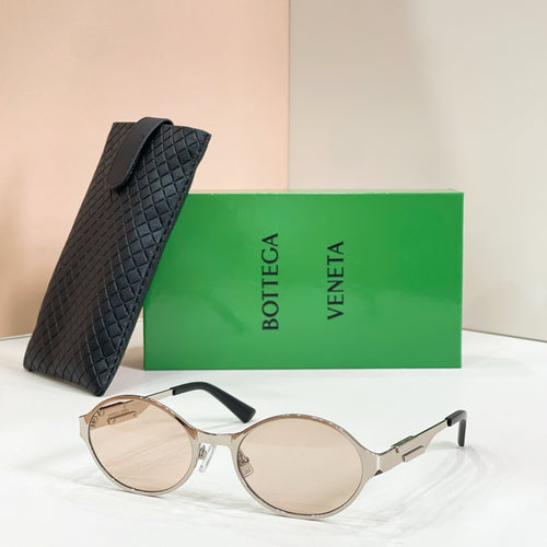 Gold-tone round sunglasses with light-tinted lenses and black quilted case