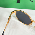 Gold-tone round sunglasses with dark tinted lens and branded temple detail