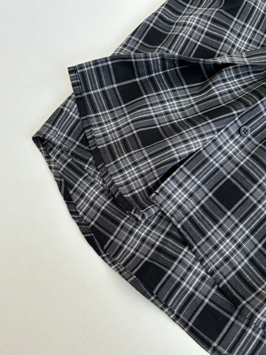 Folded long-sleeve hooded plaid shirt with dark navy sleeve cuffs and button placket
