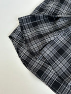 Folded long-sleeve hooded plaid shirt with dark navy sleeve cuffs and button placket