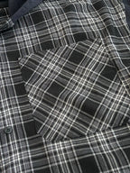 Detail view of black-and-white plaid long-sleeve hooded shirt fabric and buttons