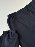 Navy long pants with elastic waistband and gold zipper fly