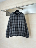 Zip-up hooded jacket in black and white plaid with front zipper and elastic cuffs