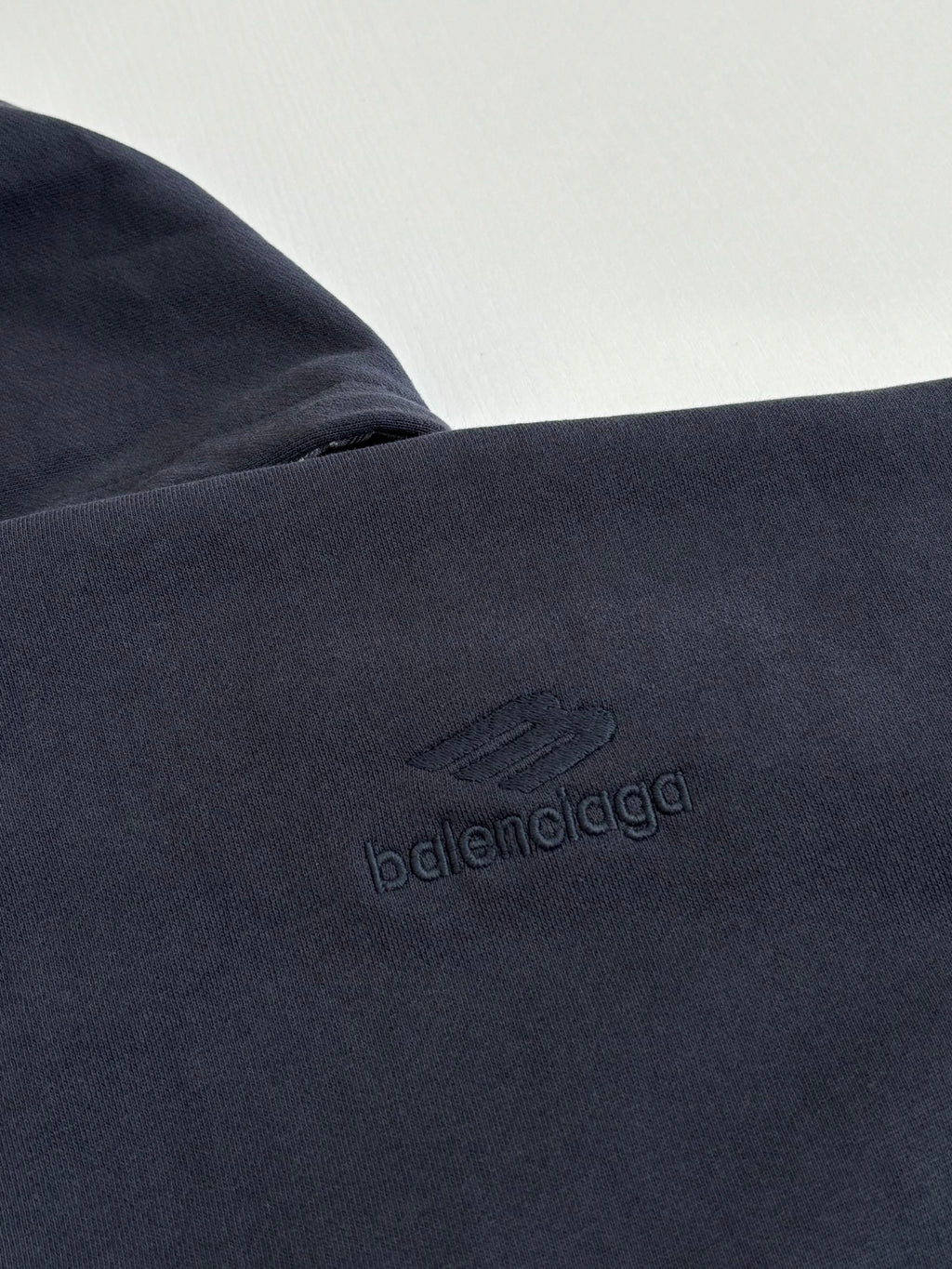 Dark navy fabric close-up with embossed Balenciaga logo