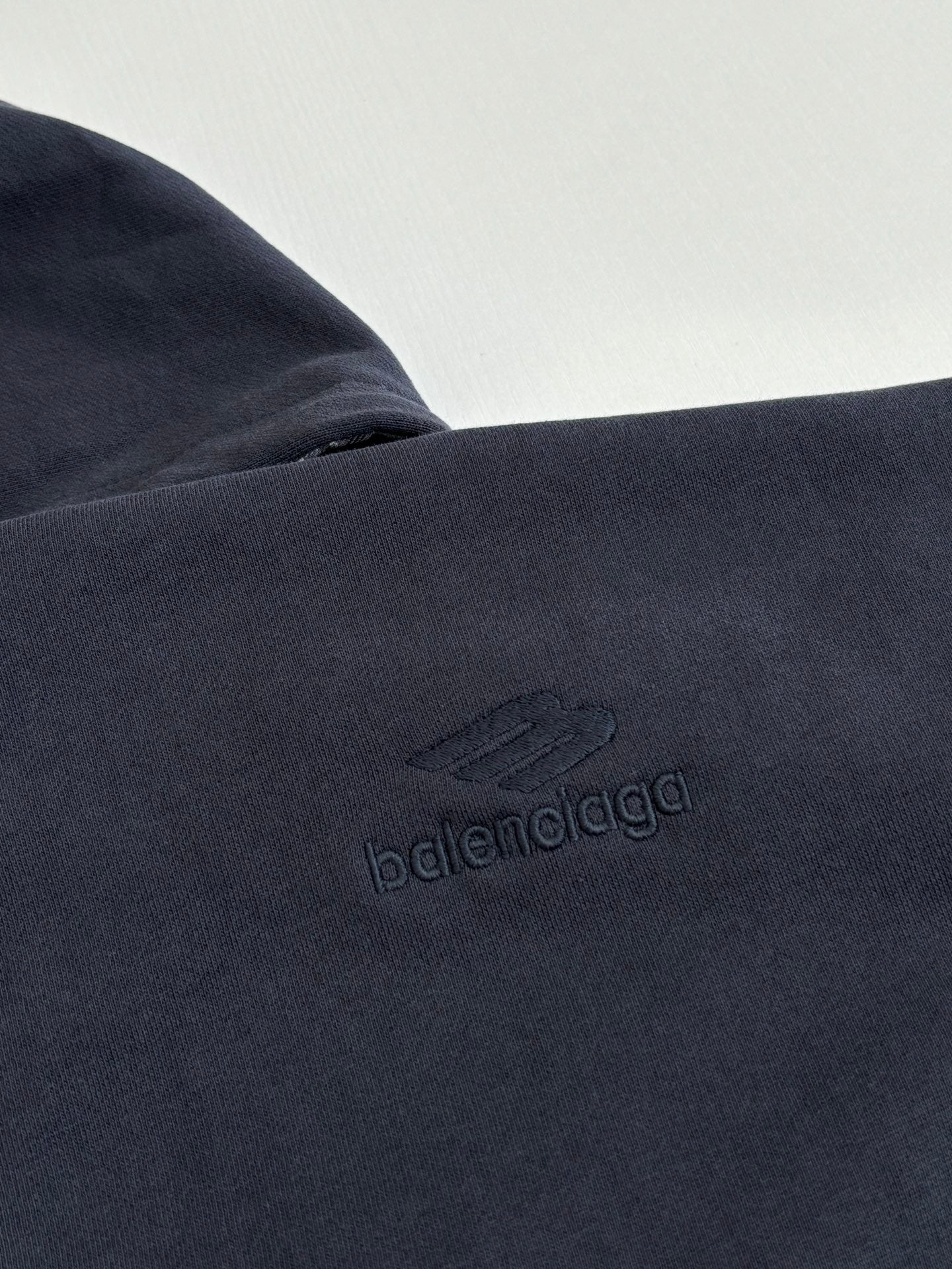 Dark navy fabric close-up with embossed Balenciaga logo