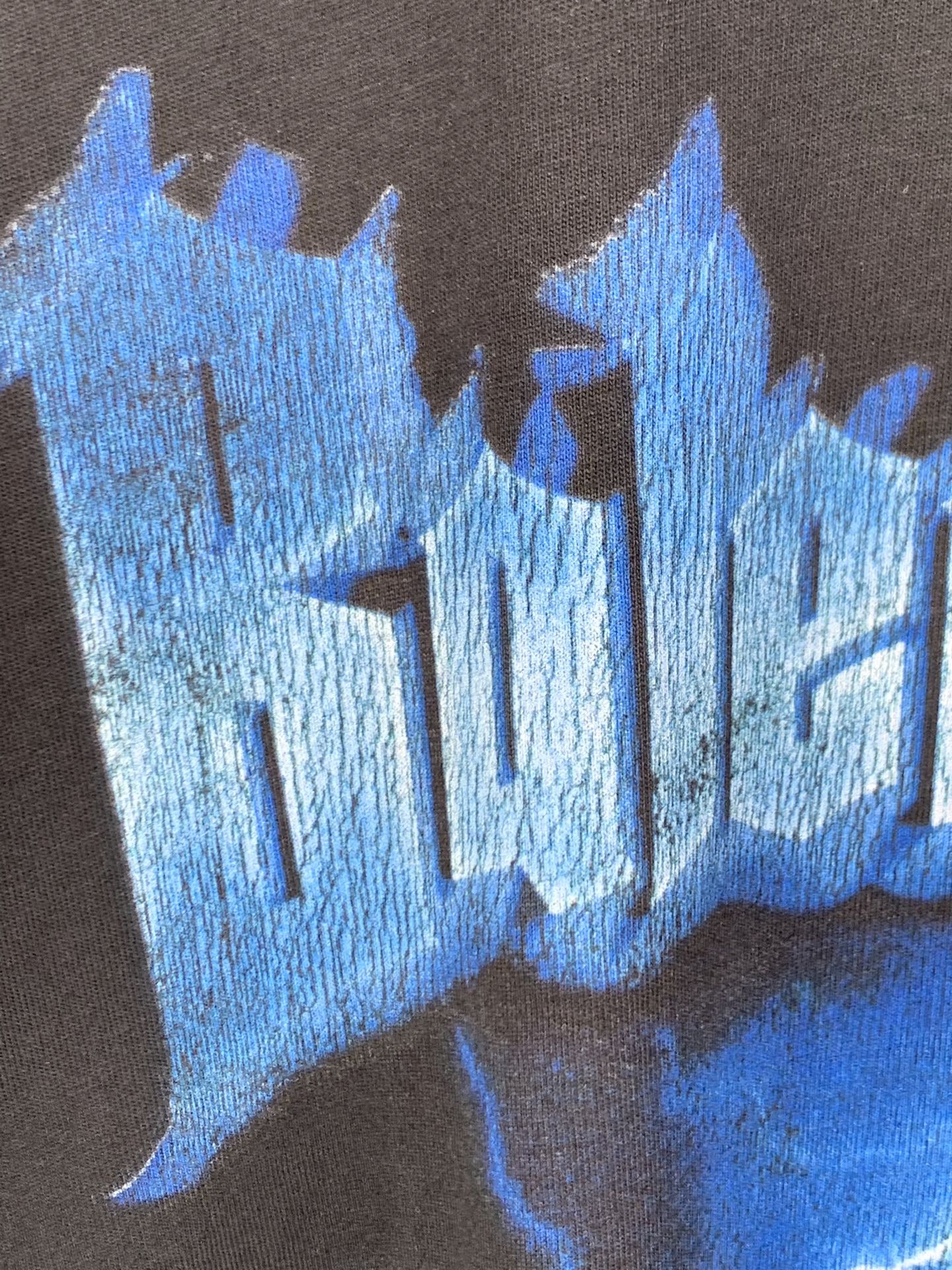 Blue lightning and castle-style graphic print on black T-shirt