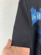 Black T-shirt hem and side seam detail with partial blue graphic