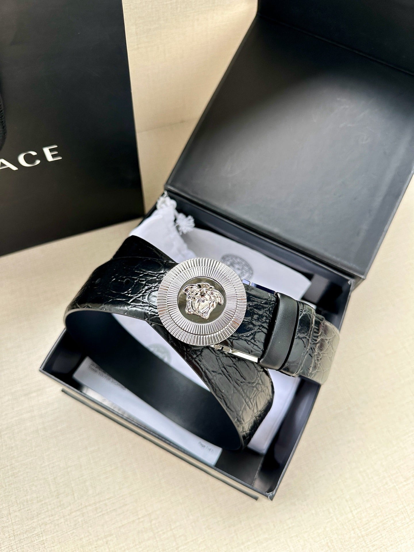 Dark blue embossed leather belt with silver Medusa buckle in gift box