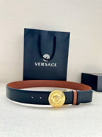 Versace belt with gold medallion buckle and dark navy strap, orange underside accent