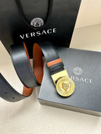 Versace belt with gold medallion buckle, dark navy strap and orange inner band