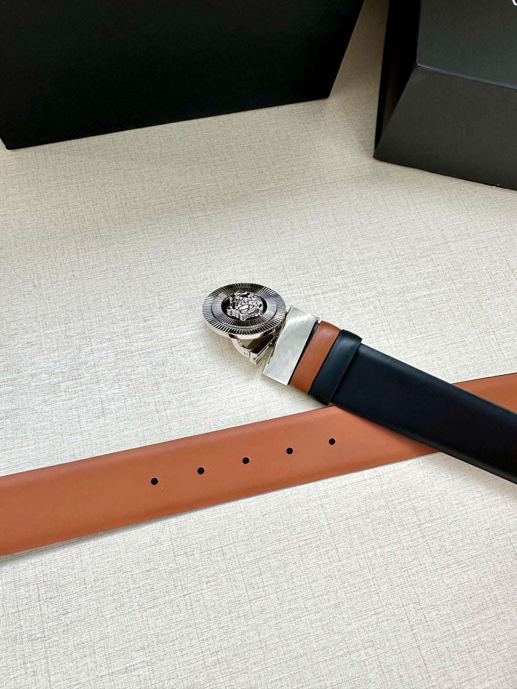 Navy leather belt with round silver Medusa buckle and tan leather trim
