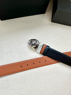 Navy leather belt with round silver Medusa buckle and tan leather trim