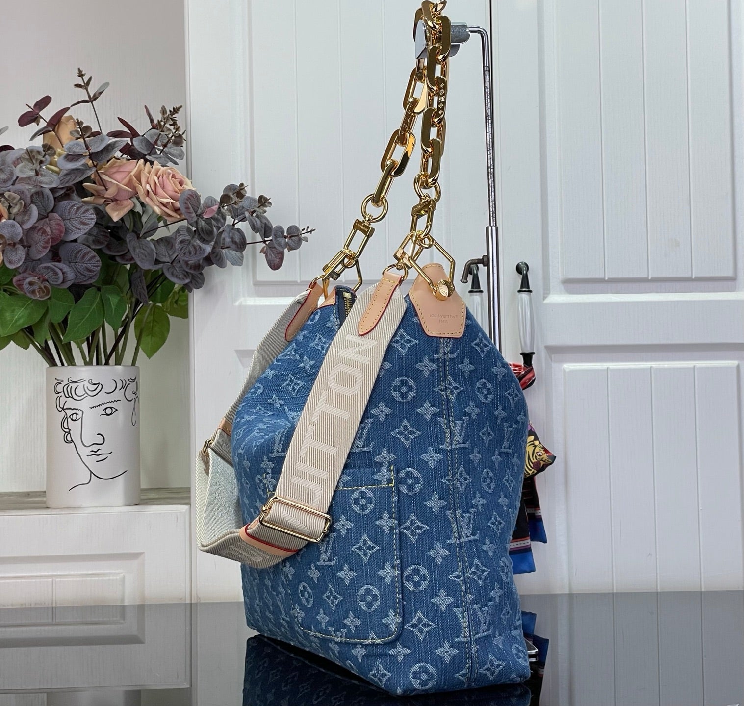 Louis Vuitton monogram hobo bag in blue with attached strap and gold hardware