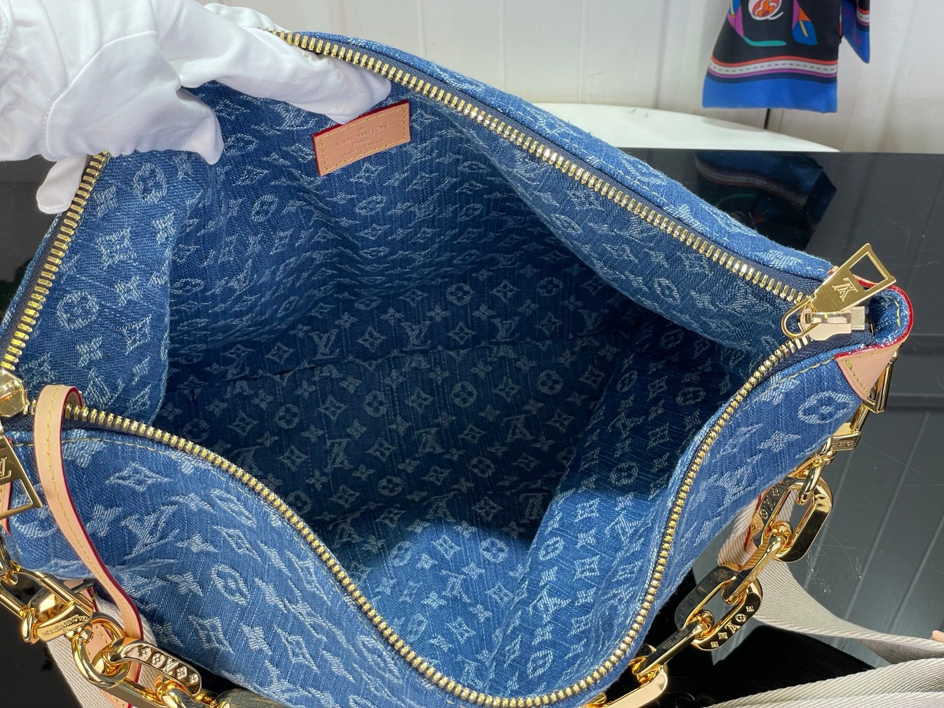 Louis Vuitton blue monogram bag open interior with fabric lining and zipper trim